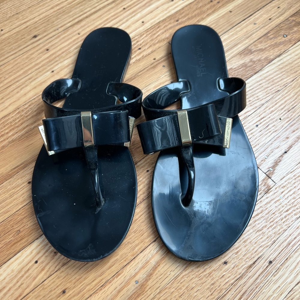 Michael Kors flat sandals with bow in black and gold embellishment. Size 8.